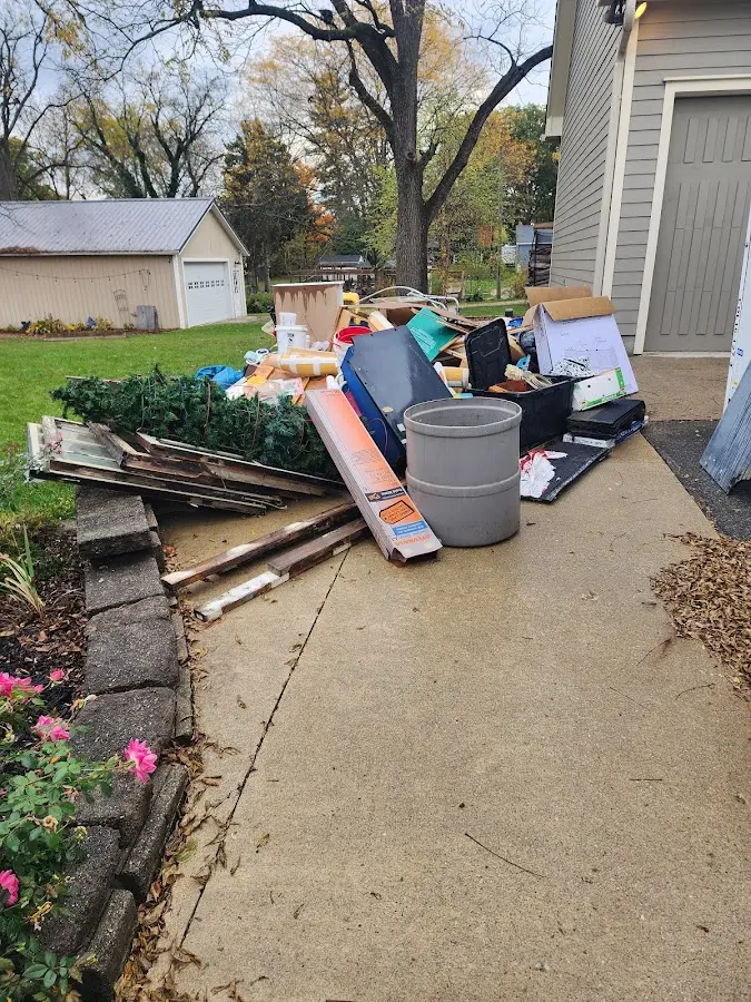 Dumpster being loaded with debris for Roofing Dumpster Rental in Olathe